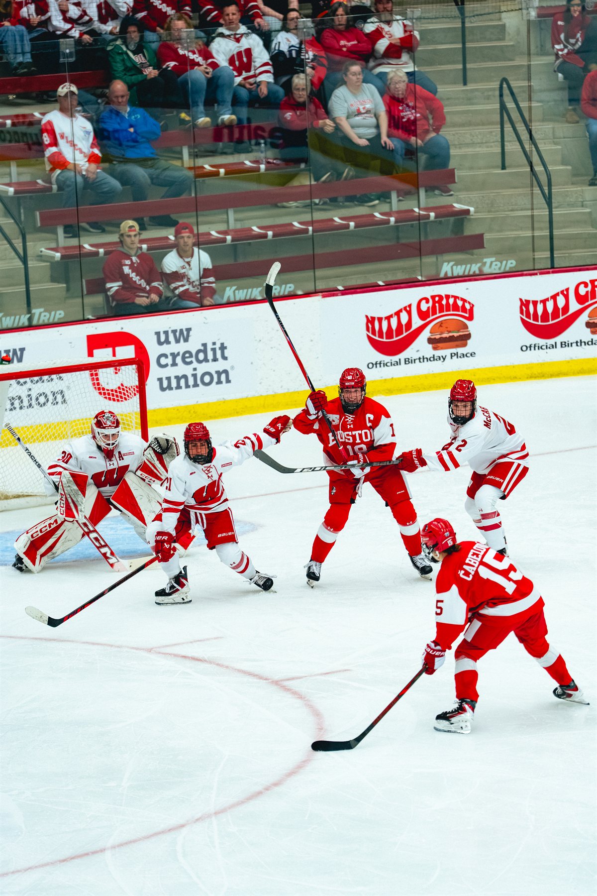 Wisconsin and Boston University players gathered in front of the Wisconsin goal